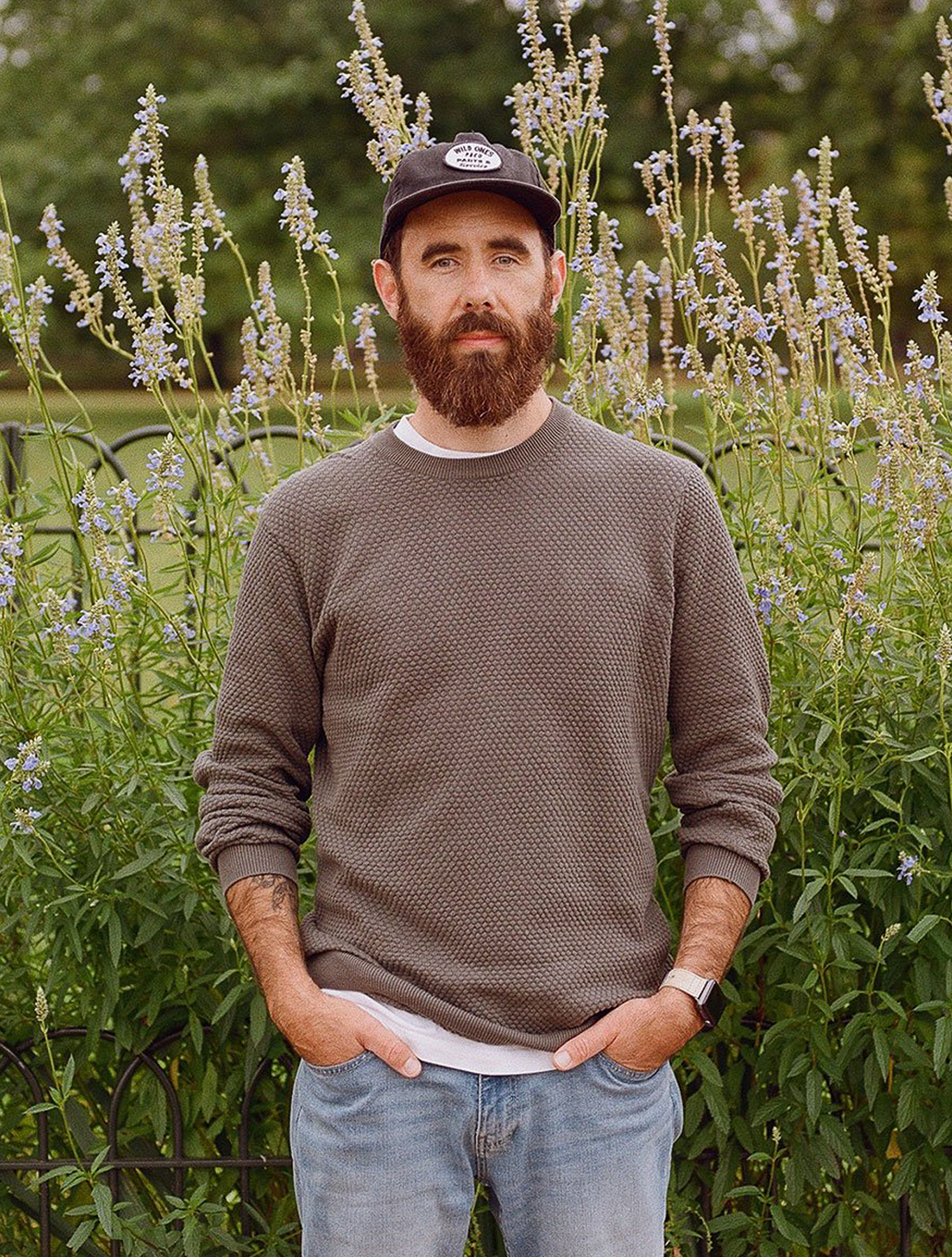 Photograph of the photographer against a backdrop of flowers.